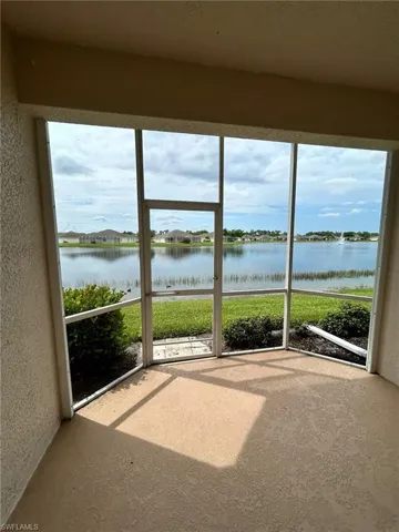 Unfurnished sunroom with a water view and plenty of natural light