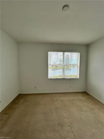Spare room with light colored carpet