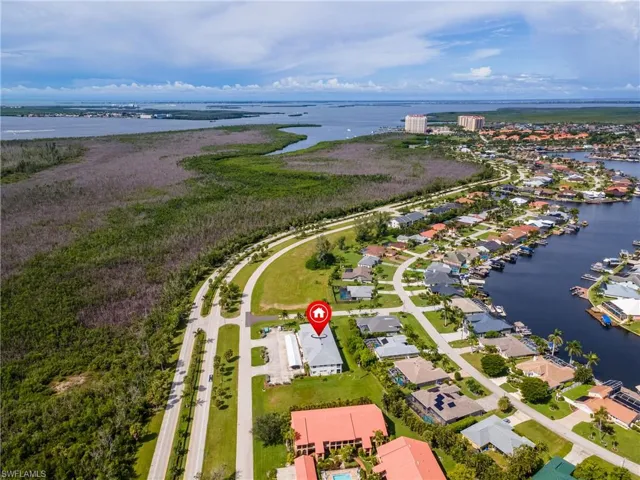 Aerial perspective of suburban area with a large body of water