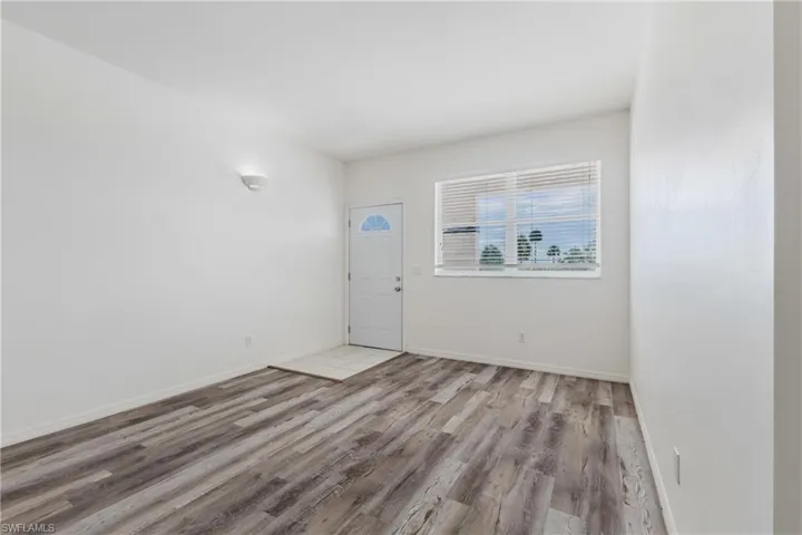 Entrance foyer with light wood-style floors and baseboards