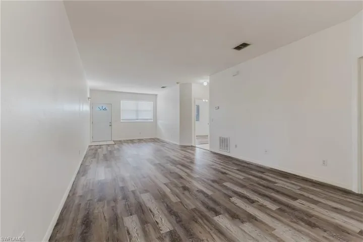 Spare room featuring wood finished floors and baseboards