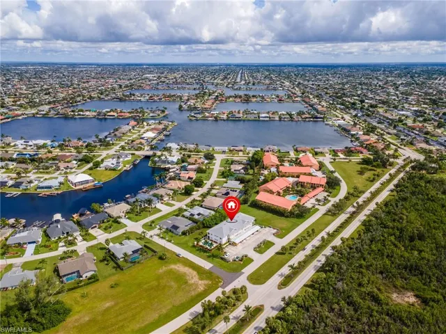 Aerial perspective of suburban area featuring a large body of water