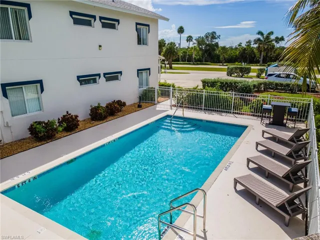Community pool with a patio