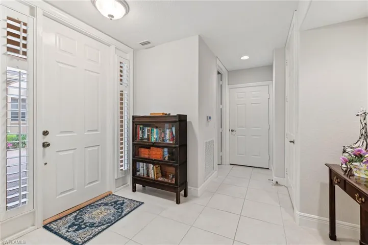 Foyer entrance featuring light tile patterned floors