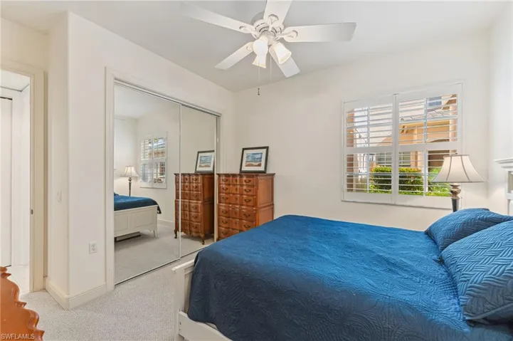 Guest bedroom featuring ceiling fan and a closet