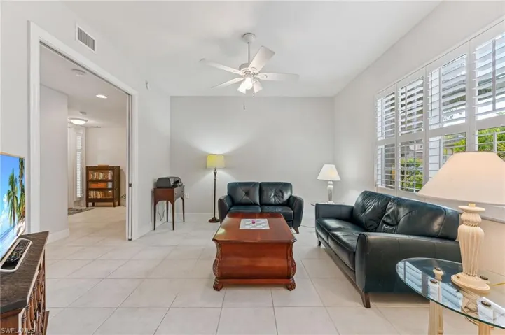 Tiled den/office featuring ceiling fan