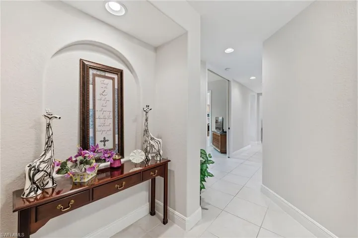 Foyer entry hallway with light tile patterned floors