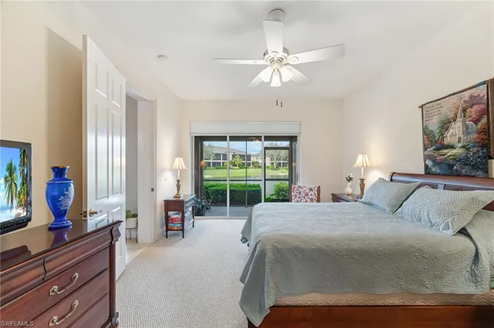 Primary bedroom with access to exterior and ceiling fan