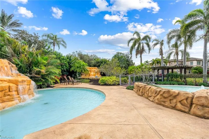 Regency Reserve community pool with waterfall, pergola, and covered patio