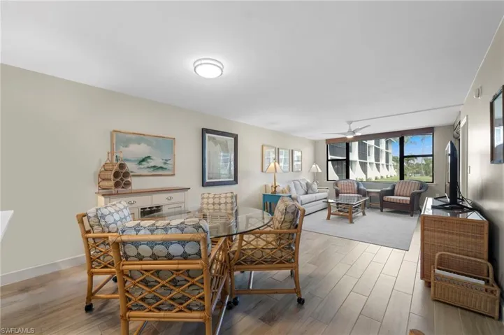 Dining room with light wood finished floors and a ceiling fan