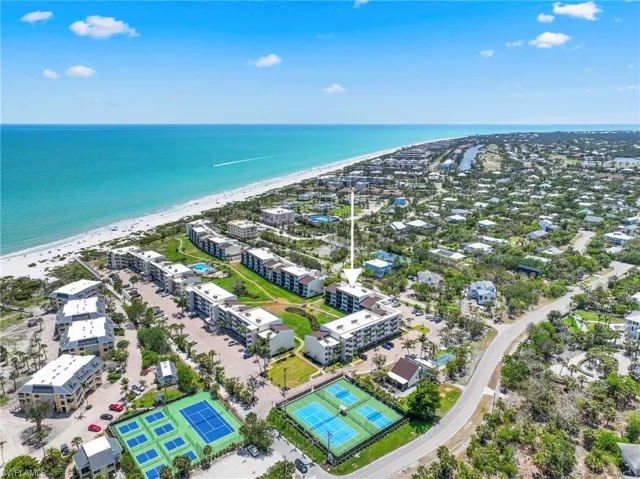 Aerial view of extended coastline and apartment complex / building