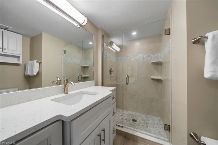 Bathroom with vanity and a stall shower