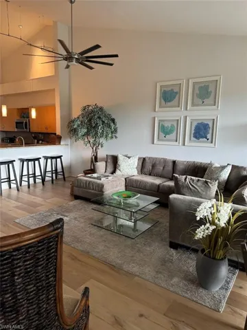 Living room featuring wood finished floors and a ceiling fan