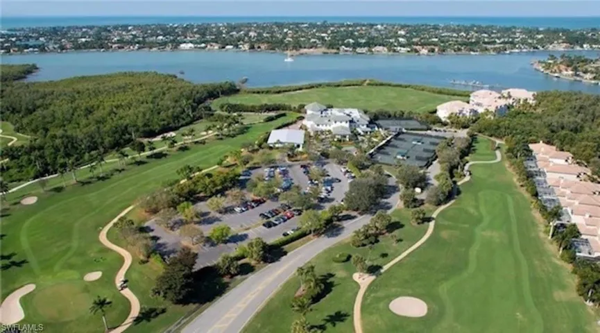 Aerial overview of property's location featuring a large body of water and a golf course
