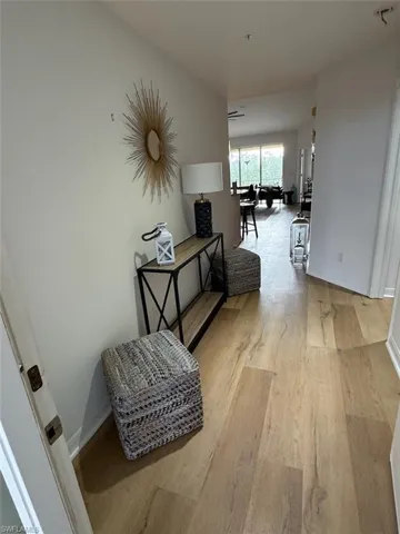Hallway featuring light wood-style floors and baseboards