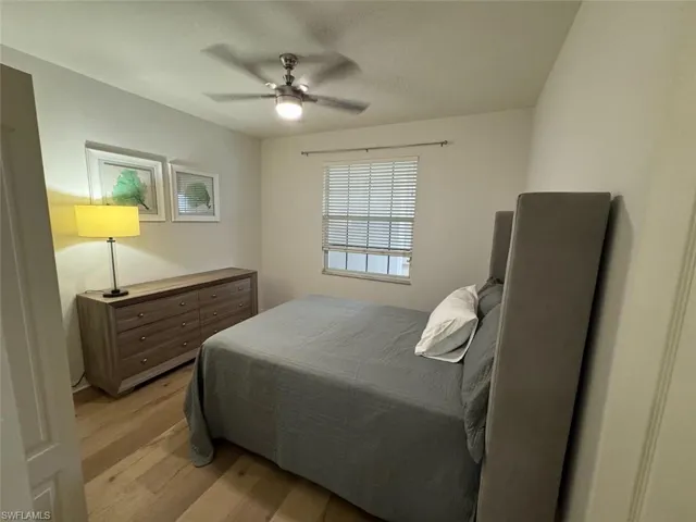 Bedroom with light wood-style floors and a ceiling fan