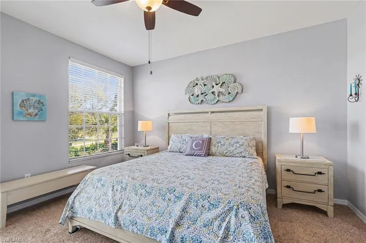 Bedroom featuring dark carpet and ceiling fan