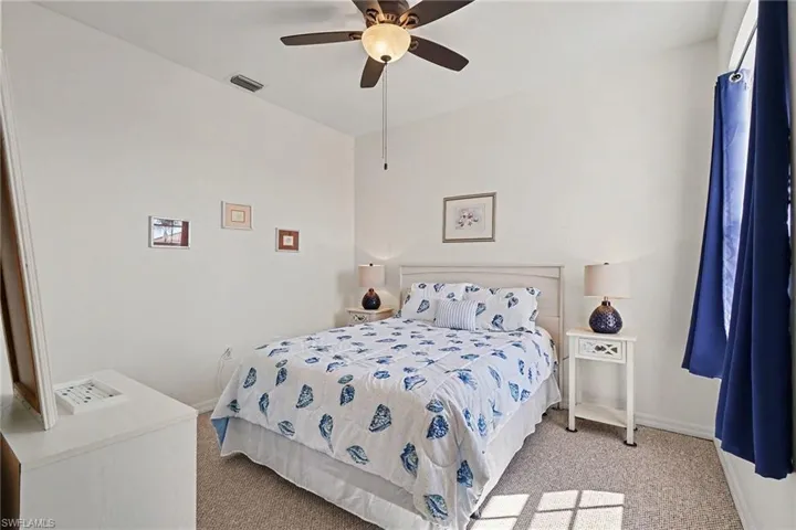 Bedroom featuring light colored carpet and ceiling fan