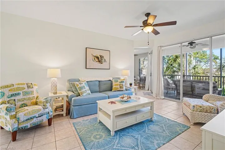 Living area featuring ceiling fan and light tile patterned floors