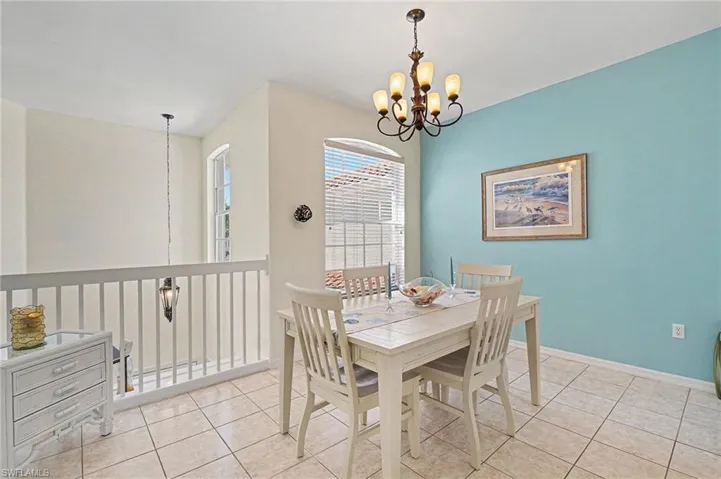 Dining area with a chandelier and light tile patterned floors