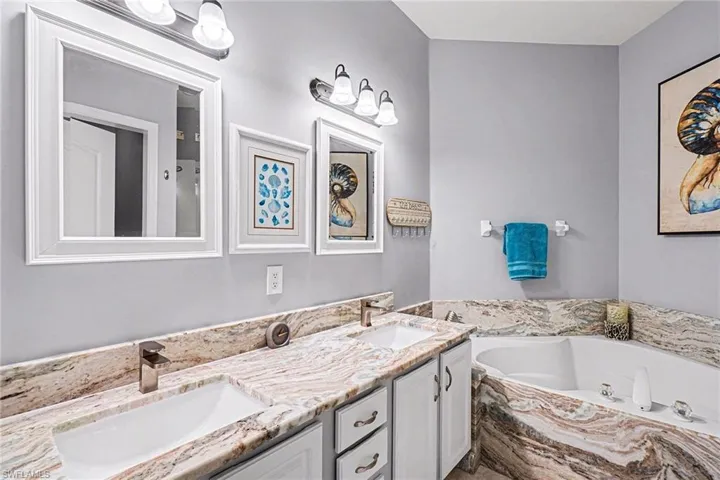 Full bath with double vanity and a garden tub