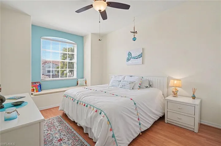 Bedroom with light wood finished floors and ceiling fan