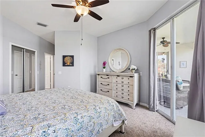 Bedroom featuring access to exterior, light carpet, and ceiling fan