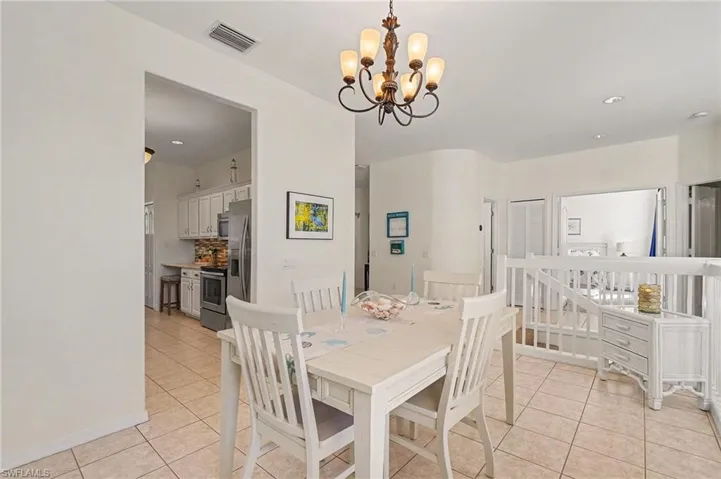Dining room featuring light tile patterned floors and a chandelier