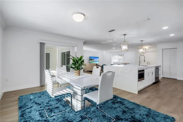 Dining, kitchen and living room are open to one another.