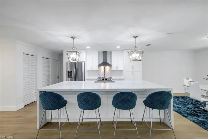 Recently renovated kitchen features shaker cabinets, quartz countertops and stainless appliances.