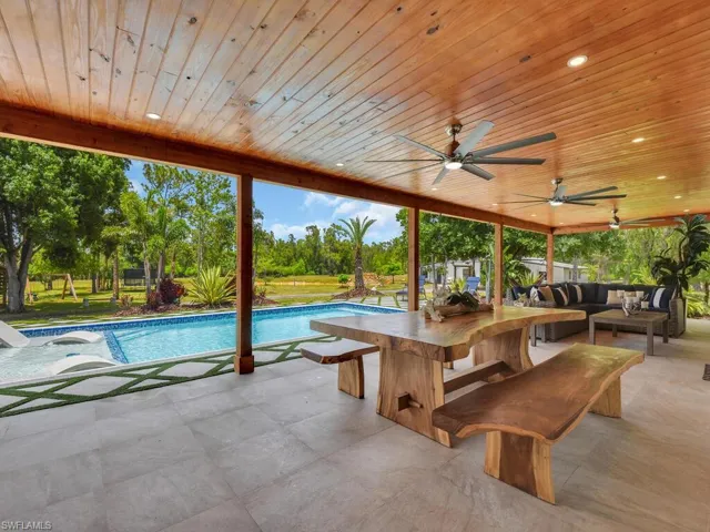 View of swimming pool with ceiling fan, a patio area, and an outdoor hangout area