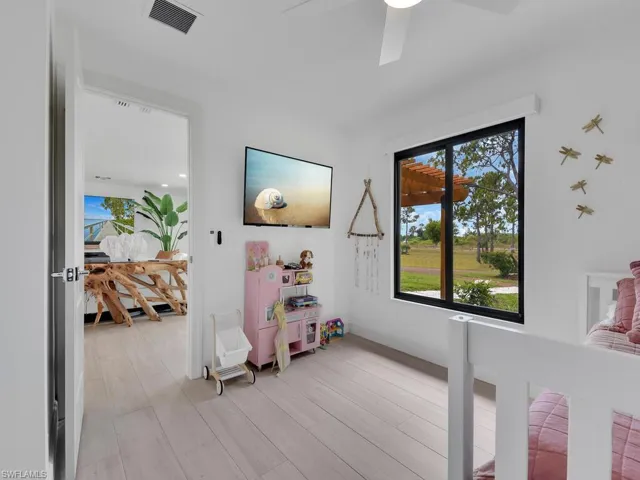 Bedroom with ceiling fan and light hardwood / wood-style flooring