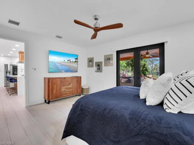 Bedroom with access to outside, french doors, light wood-type flooring, and ceiling fan
