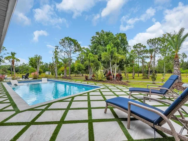 View of pool with a patio and a yard