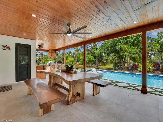View of pool with ceiling fan