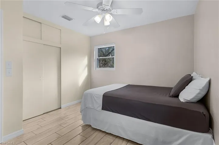 Bedroom featuring a closet, light hardwood / wood-style floors, and ceiling fan