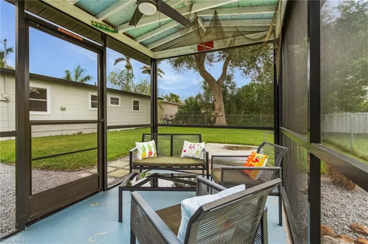 Sunroom / solarium featuring ceiling fan and lofted ceiling
