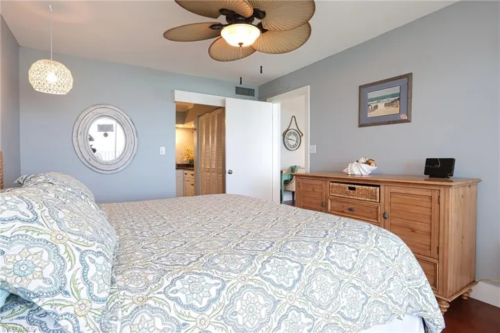 Bedroom with ceiling fan and hardwood / wood-style flooring