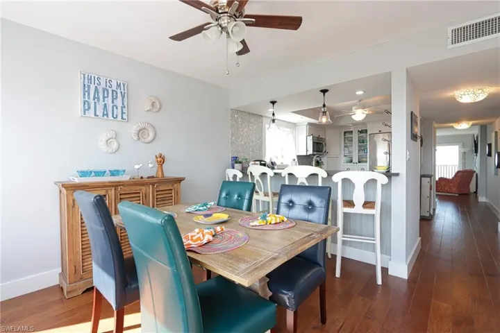 Dining space with wood-type flooring and ceiling fan