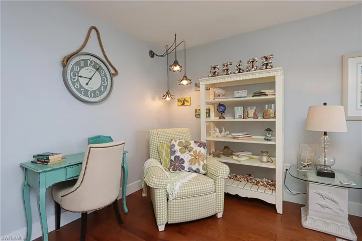 Living area with dark hardwood / wood-style floors
