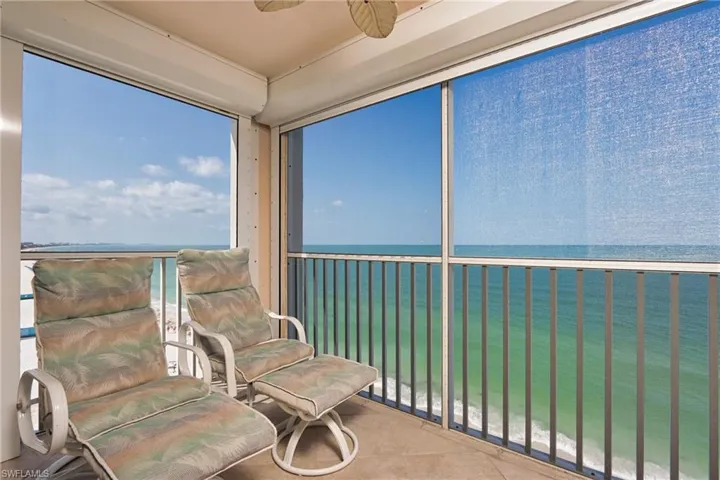 Sunroom / solarium featuring ceiling fan and a water view
