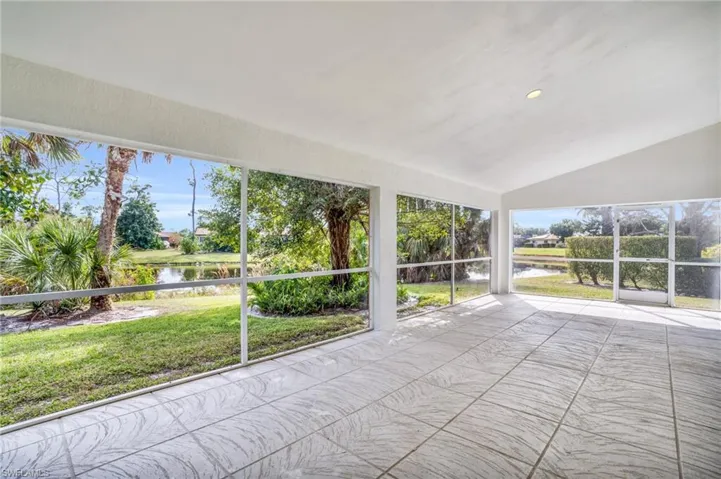 Unfurnished sunroom with a healthy amount of sunlight, a water view, and lofted ceiling