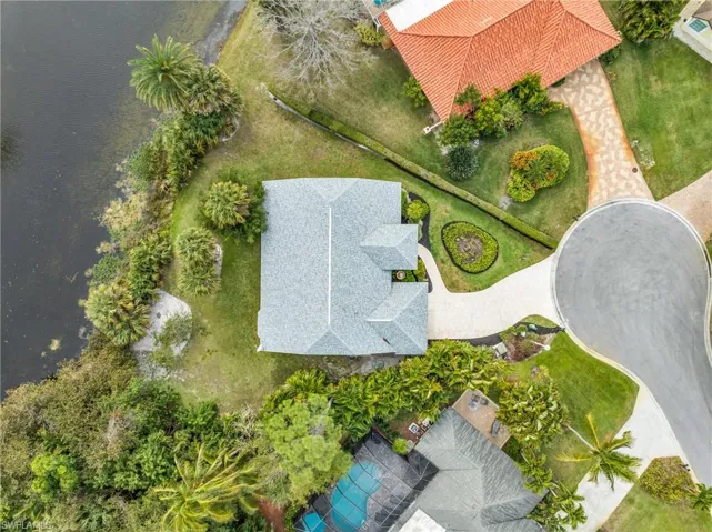 Birds eye view of property with a water view