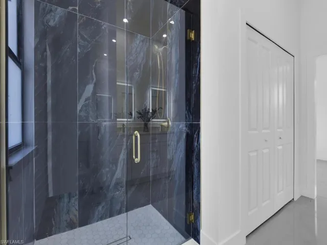 Full bathroom featuring a marble finish shower