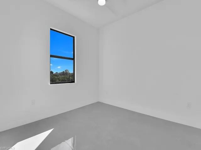 Empty room featuring baseboards