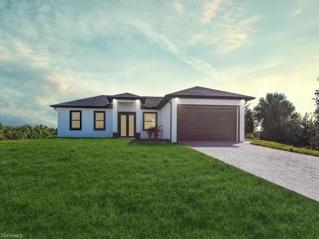 Prairie-style home with a garage, stucco siding, a lawn, decorative driveway, and a shingled roof