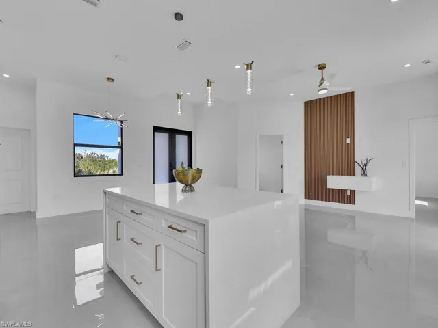 Kitchen featuring open floor plan, white cabinetry, recessed lighting, and a ceiling fan