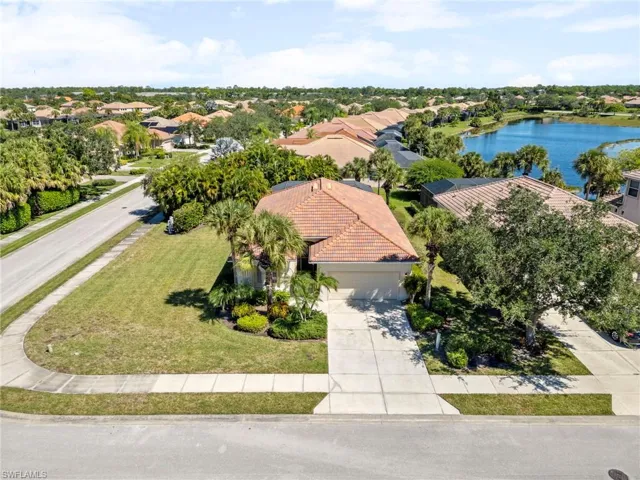 Aerial view of residential area featuring a nearby body of water