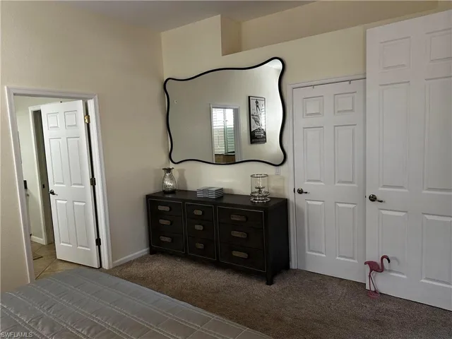 Bedroom with carpet floors and baseboards