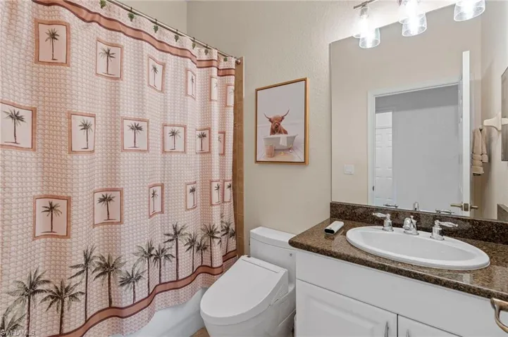 Bathroom featuring vanity and shower / tub combo
